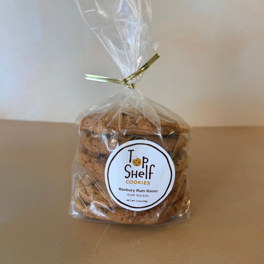 Packaged cookies with a 'Top Shelf Cookies' label on a beige surface.