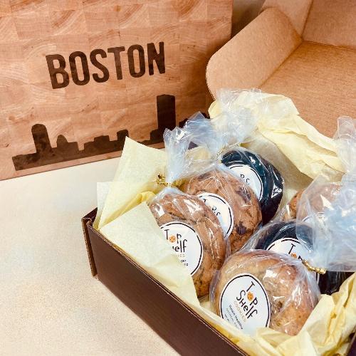 Box of pastries with 'Boston' engraved on a wooden box in the background