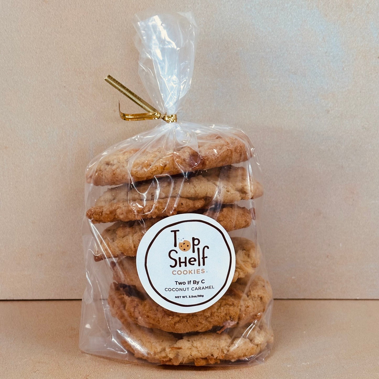 Packaged cookies with a 'Top Shelf' label on a beige background
